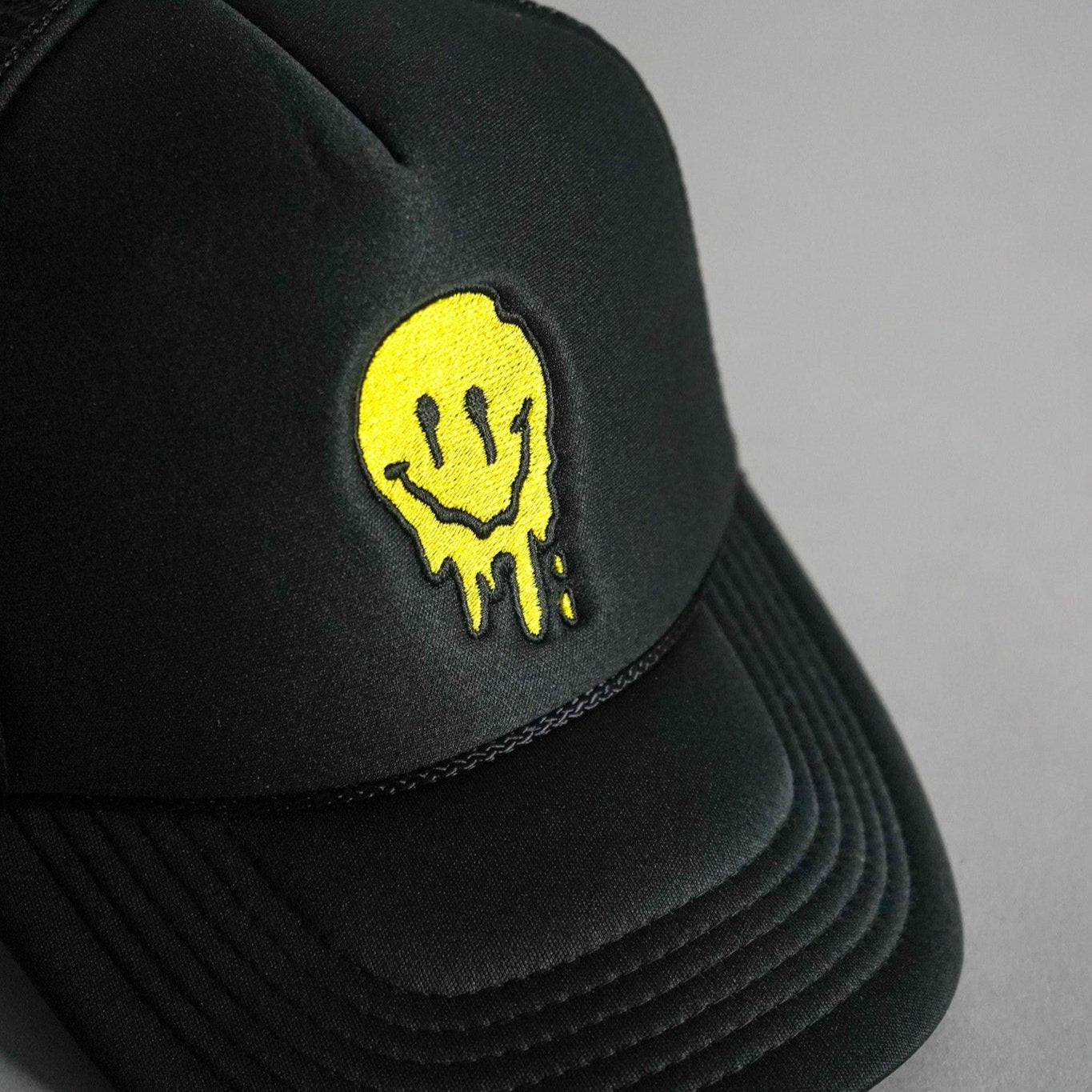 Melted Smiley Face Trucker Hat - Black