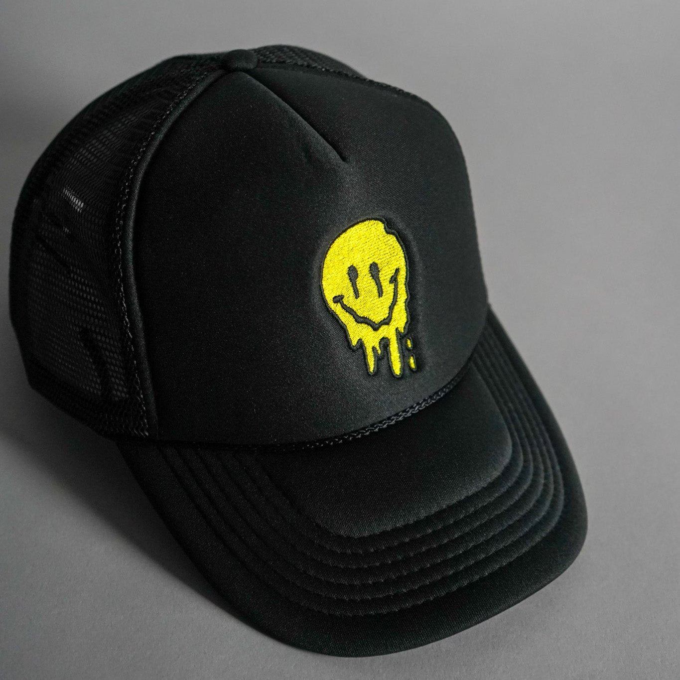 Melted Smiley Face Trucker Hat - Black