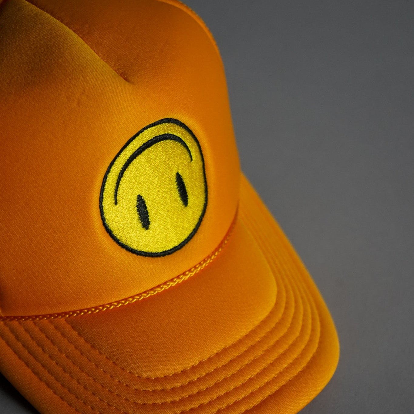 Upside Down Smiley Face Trucker Hat - Gold