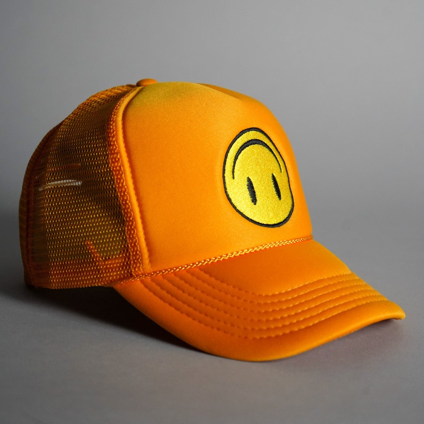 Upside Down Smiley Face Trucker Hat - Gold