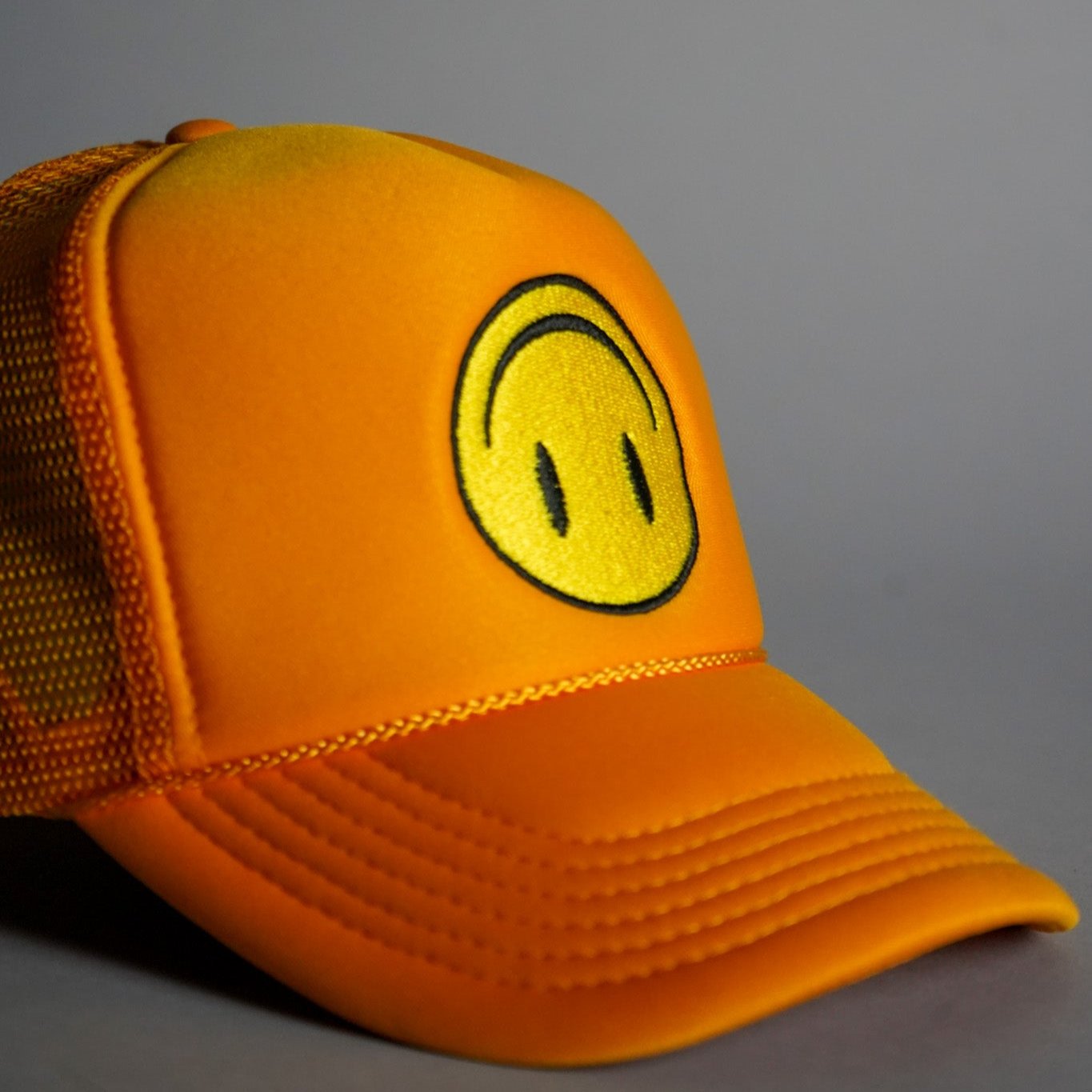 Upside Down Smiley Face Trucker Hat - Gold