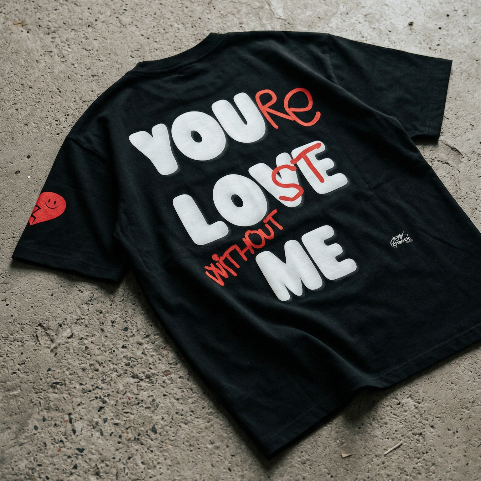 Black t-shirt with text 'YOU'RE LOST WITHOUT ME' on a concrete floor